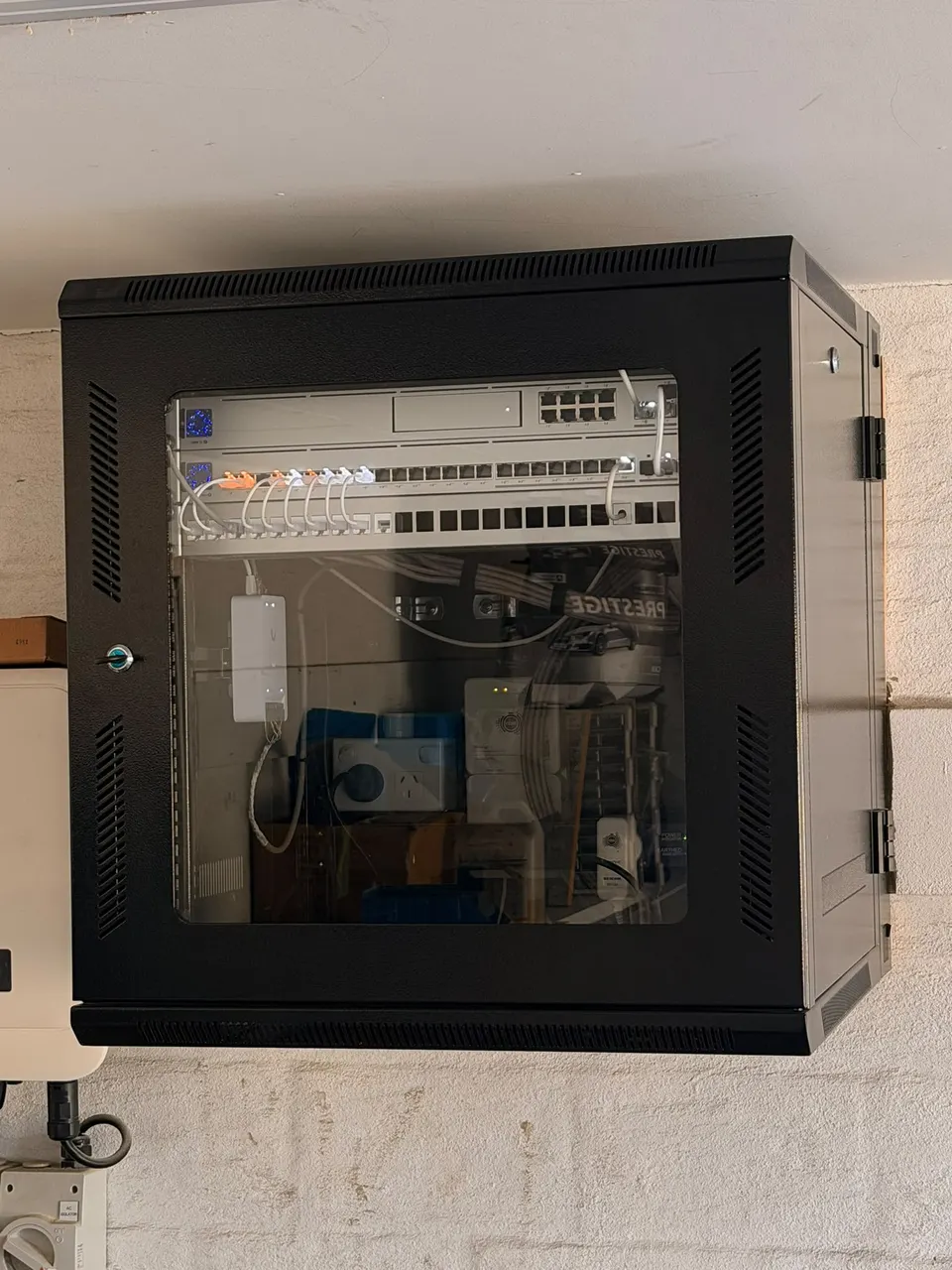 Wall-mounted network cabinet with UniFi equipment