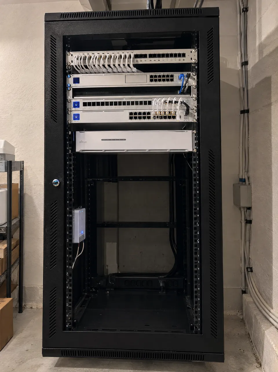 Illustrative full-height network cabinet with UniFi equipment